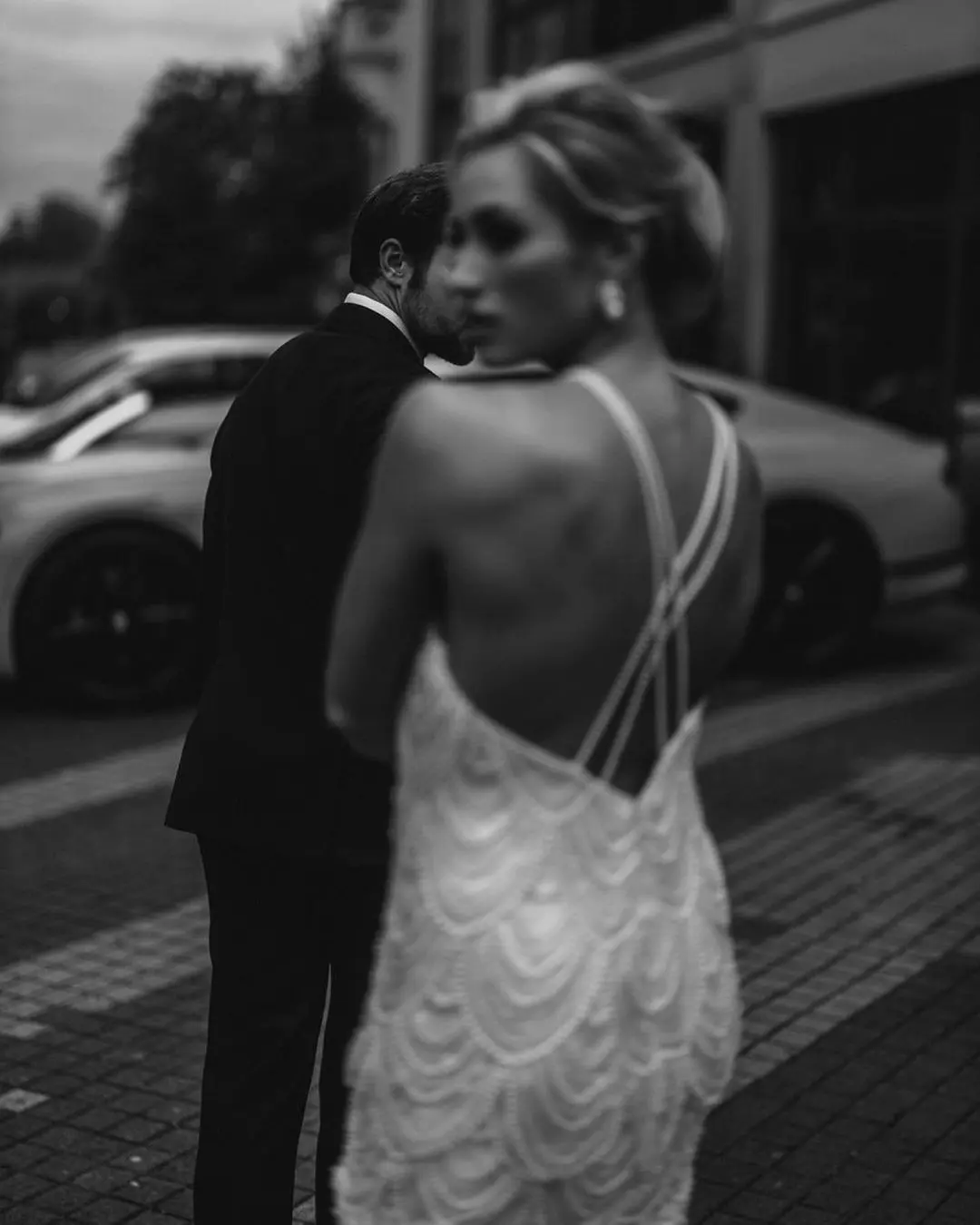 Novios caminando juntos por una bulliciosa calle de la ciudad, simbolizando su viaje de vida compartido tras los votos matrimoniales