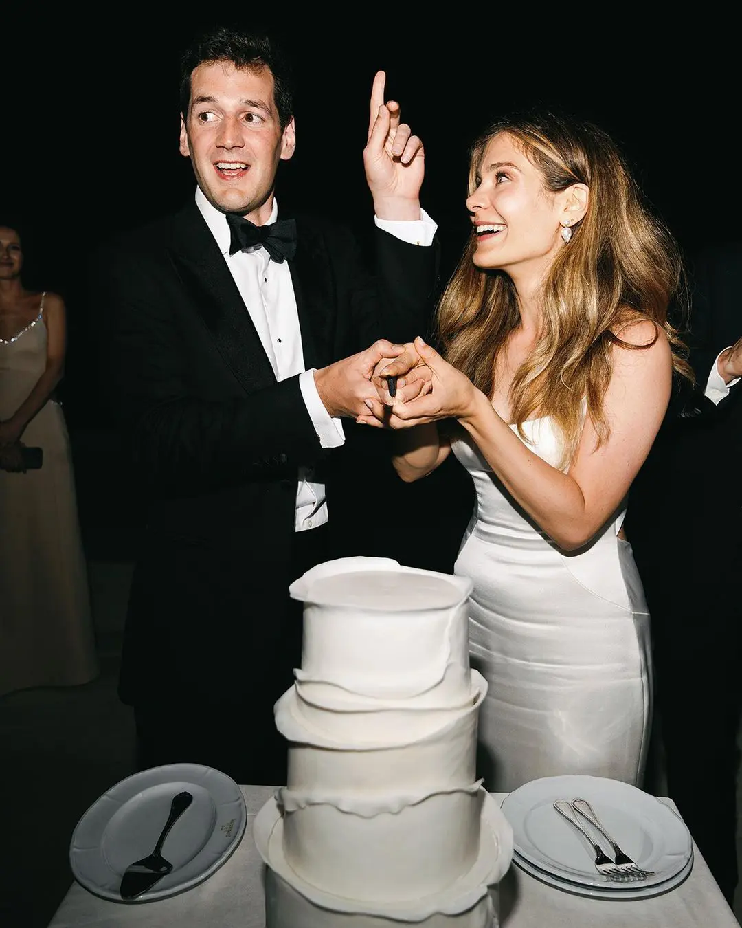 Novios a punto de cortar la tarta, captando un instante lleno de dulzura en una de las mejores fechas para casarse según la astrología en 2025